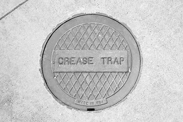 signs that indicate your grease trap needs to be pumped include slow drainage, foul odors, and grease buildup in the drain